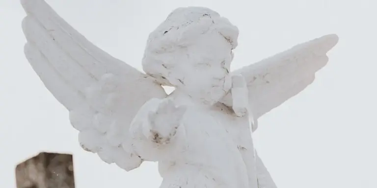 White stone angel statue with outstretched wings