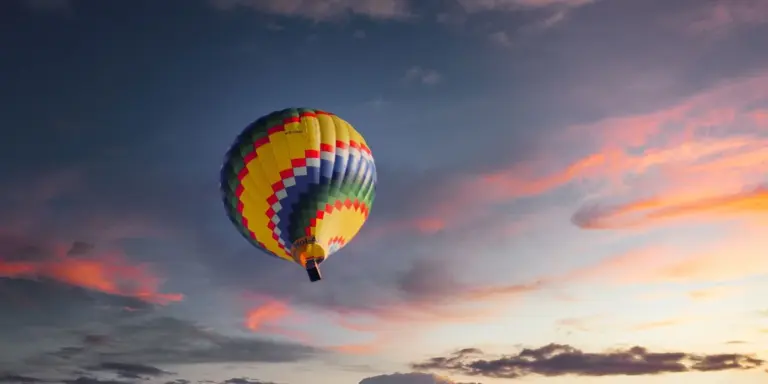 Colorful hot air balloon floating in a sunset sky
