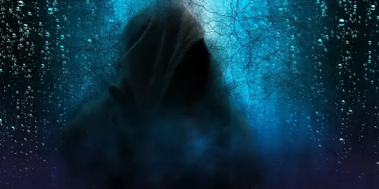 A dark hooded silhouette in a misty blue dreamlike scene, with the figure cloaked and features obscured.