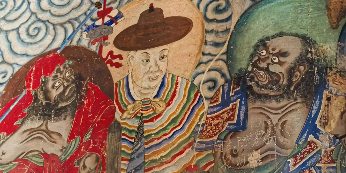 Mural of three figures in vibrant traditional attire, with swirling blue cloud patterns in the background, illustrating how cultural symbolism shapes dreams about the color blue.