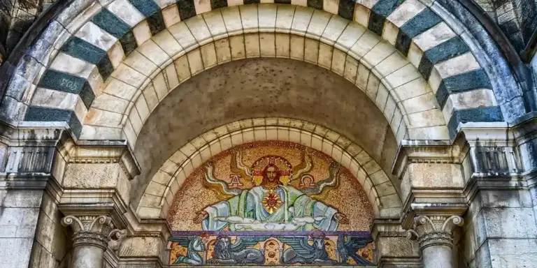 Mosaic of a haloed figure within a church arch, illustrating sacred space