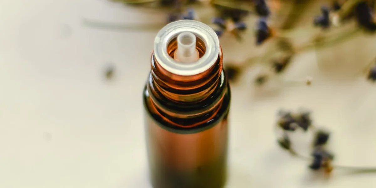 Close-up of a perfume bottle with the spray nozzle, ready to release fragrance.