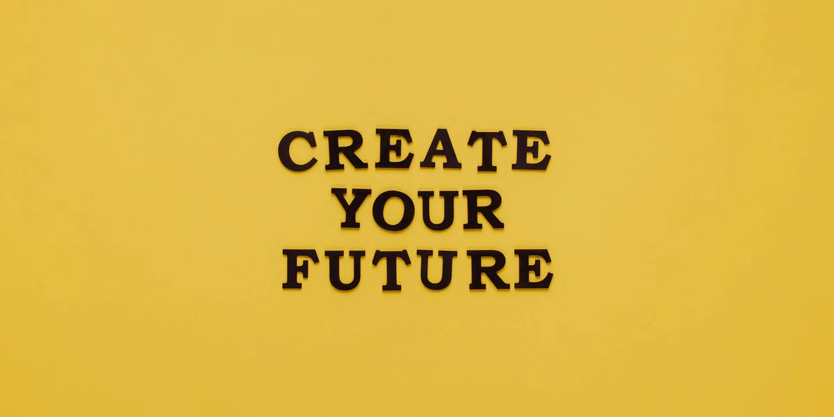 Yellow background with bold black letters reading 'CREATE YOUR FUTURE'.