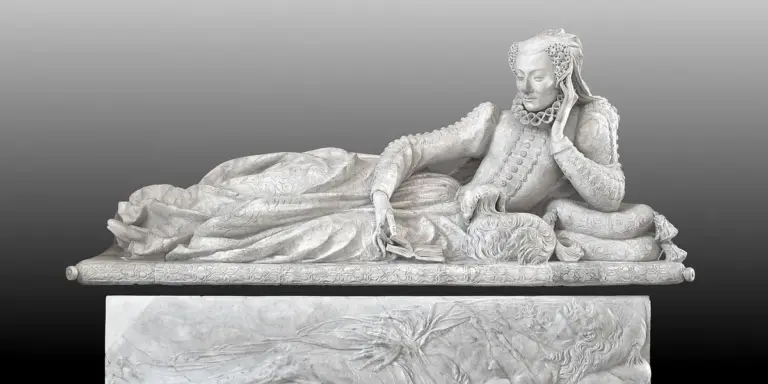 A white marble sculpture of a reclining figure on a raised pedestal, set against a grayscale gradient.