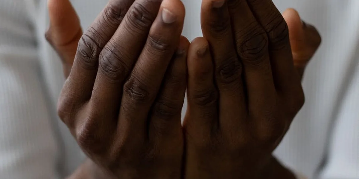 Close-up of a pair of hands held together in a prayer-like, cupped position, suggesting connection and inner transformation in dreams.