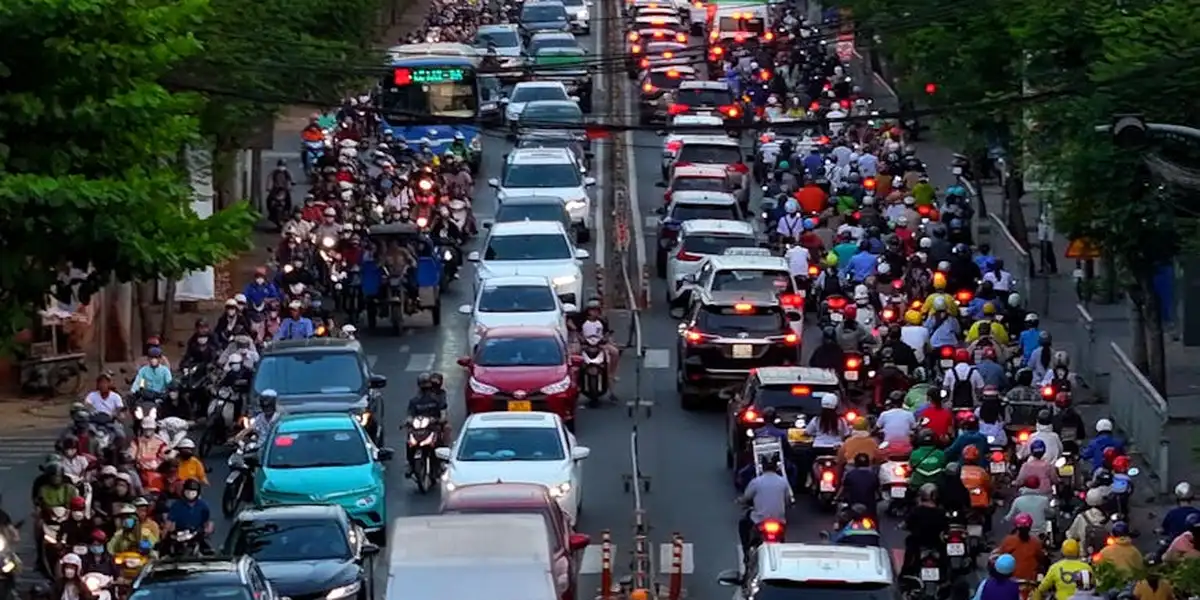 A crowded city street with bumper-to-bumper cars and motorcycles in a traffic jam, symbolizing a detour in a dream about fate and divine timing.