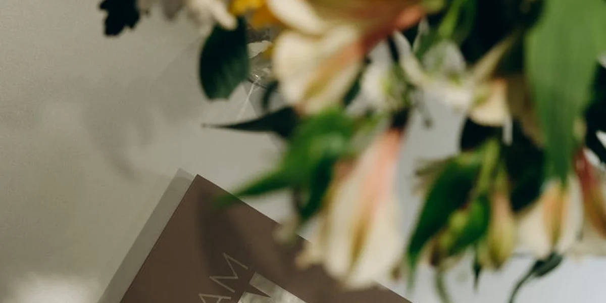 Close-up of a floral arrangement with a blurred card reading 'Dream' in the background