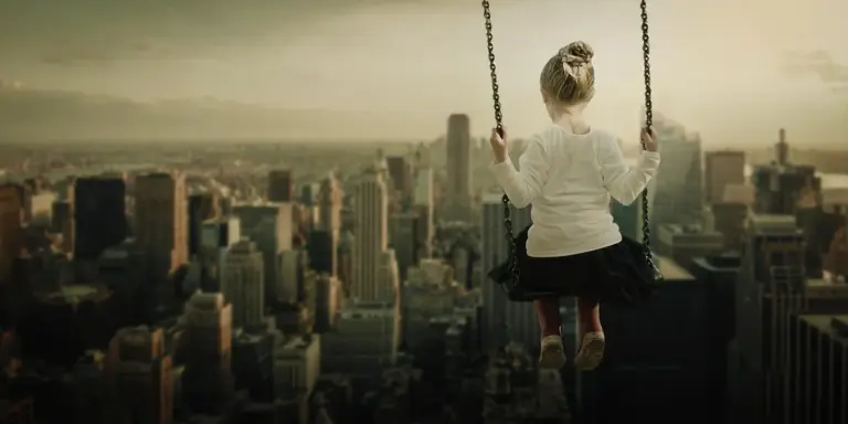 A child on a swing suspended high above a city skyline at sunset, conveying a dreamlike, imaginative moment.