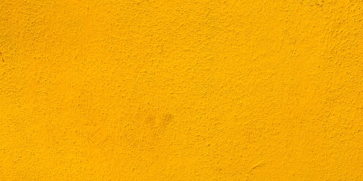 Close-up of a textured yellow wall symbolizing a barrier or boundary in dream imagery.