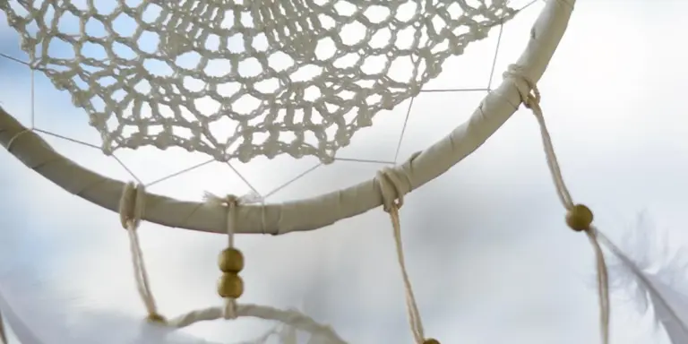 Close-up of a dreamcatcher with an intricate woven net and hanging beads