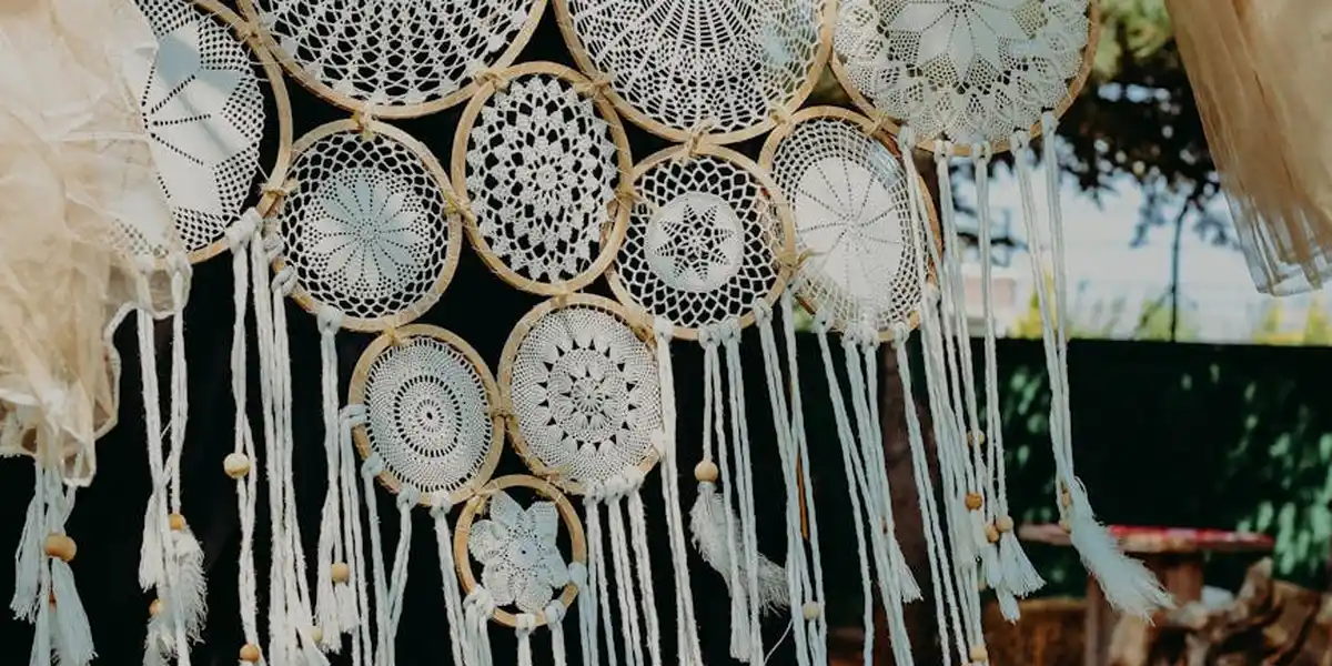 Close-up of handmade dreamcatchers hanging in a row, symbolizing guidance and protection for those experiencing recurring nightmares.