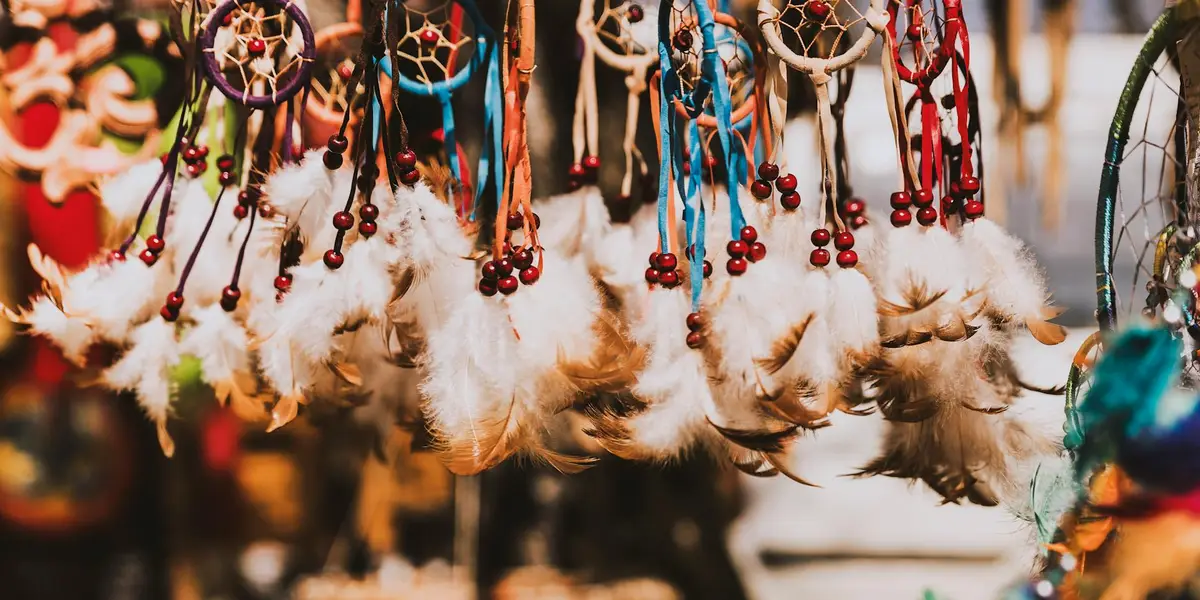 Colorful dreamcatchers with feathers hanging in a row