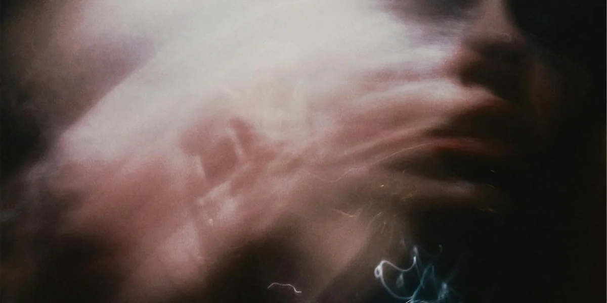 Blurry, ethereal portrait suggesting a dreamlike scene with soft lighting and abstract forms
