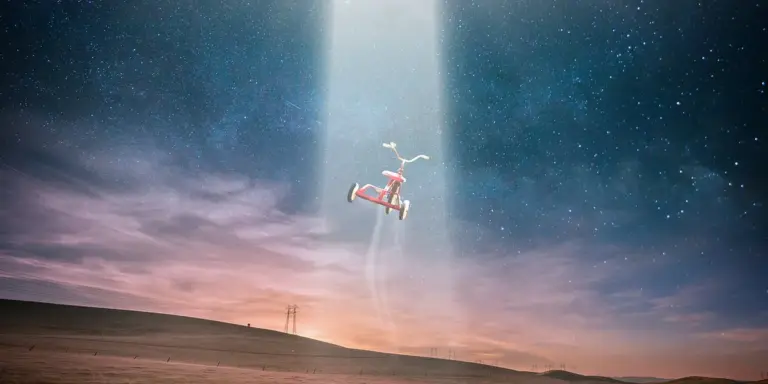 A surreal scene of a person floating in mid-air beneath a bright beam of light, with a pink and blue sky and a barren landscape below.