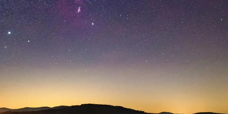 Star-filled night sky above a dim horizon at dusk, suggesting dream imagery and the exploration of hidden wishes.