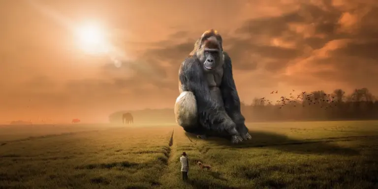 A colossal gorilla sits on a grassy plain at sunset, looming over a small human figure and a dog, in a surreal, dreamlike landscape.