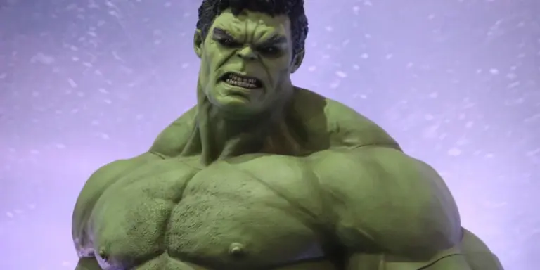 Green, muscular superhero resembling the Hulk snarling in a misty, purple-toned background.