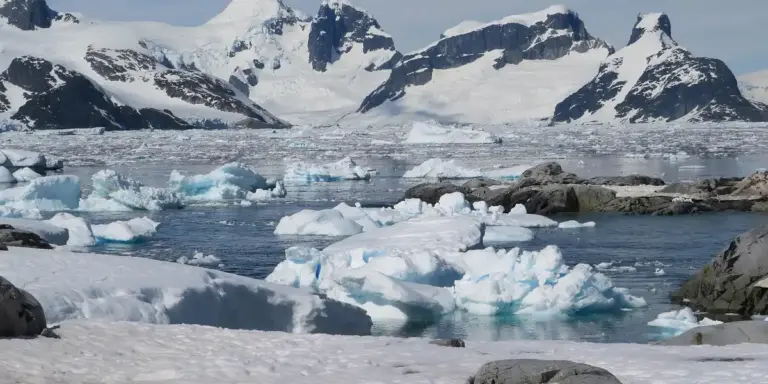 Arctic seascape with floating ice and snow-covered mountains.