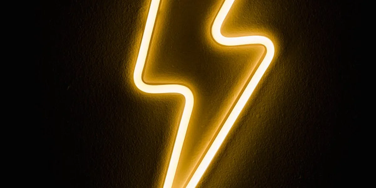 Neon yellow lightning bolt on a dark background
