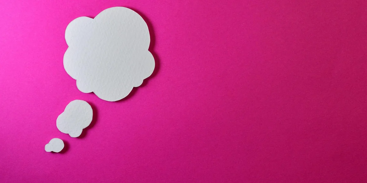 Three white thought bubbles on a bright pink background
