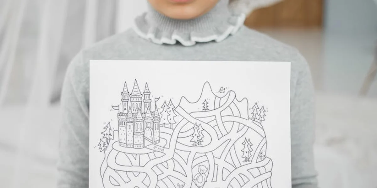 A person wearing a light gray turtleneck sweater holds a white card featuring a hand-drawn maze and a castle, symbolizing confusion and disorientation in dreams.