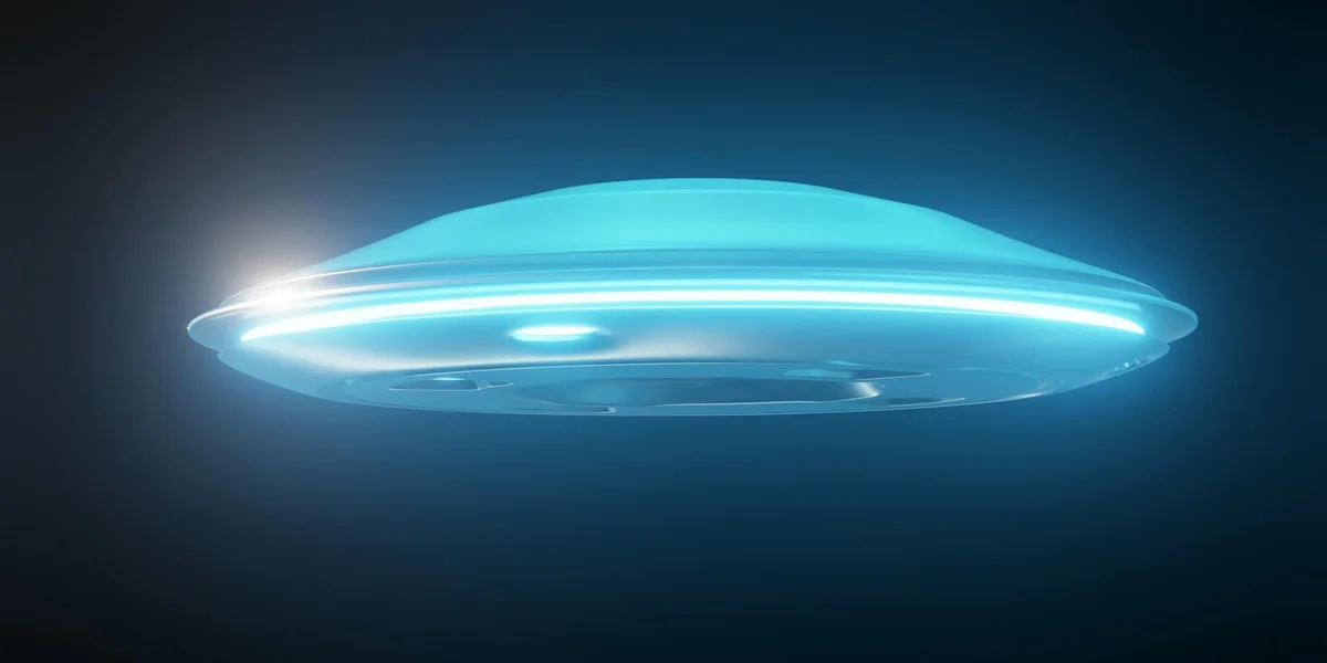 A glowing blue flying saucer/UFO hovers in a dark sky, emitting a soft halo of light.
